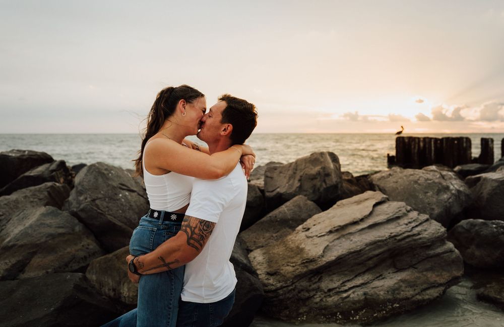 Engagement photoshoot on St. Pete Beach with a coastal sunset as the background. Romantic Tampa Bay coastal vibes.