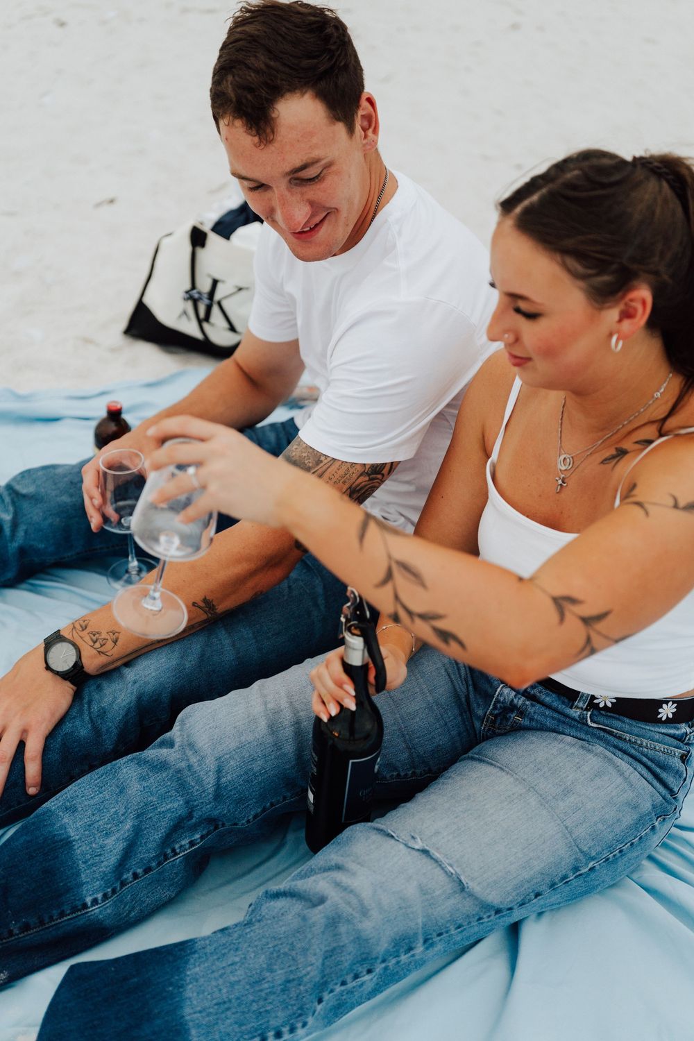 Engagement photoshoot on St. Pete Beach with picnic setup, wine, and relaxed Tampa Bay coastal vibes.