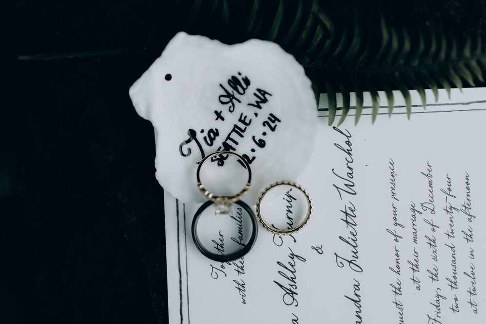 A close-up view of handwritten text in black ink on white paper with decorative elements visible.