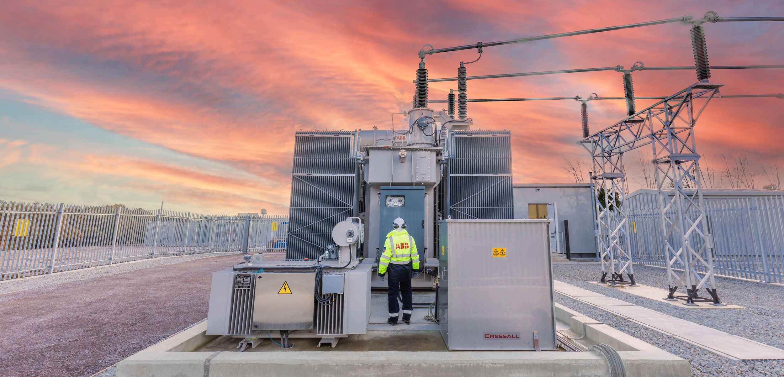 Dramatic sunset over National Grid power pylon and electrical infrastructure, specialist technical photography by AHP Photo.