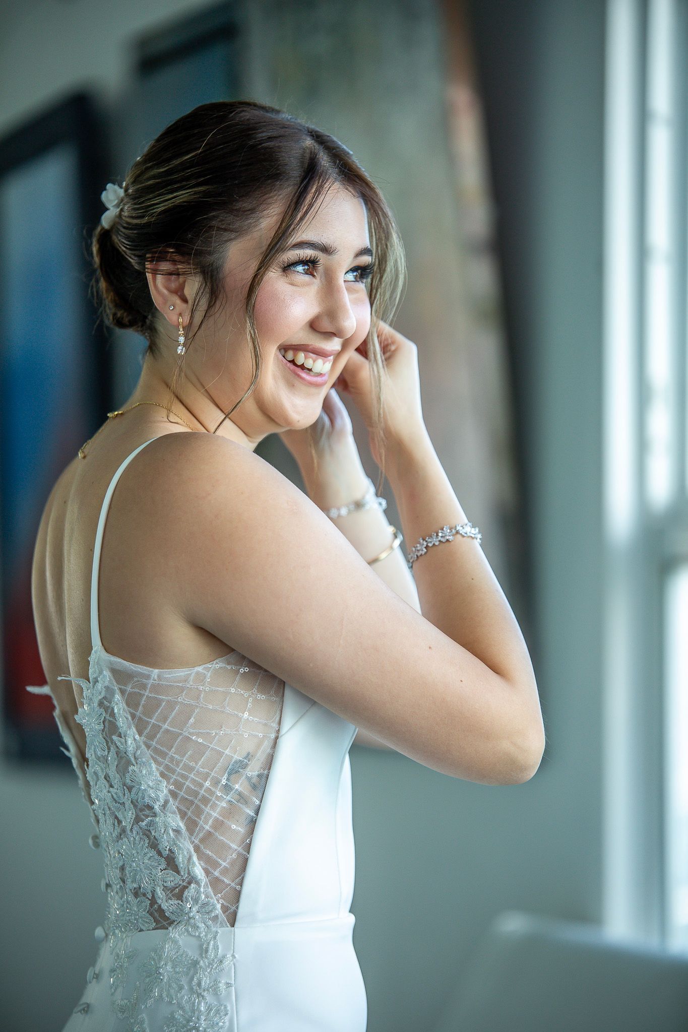 Multiple portrait shots of a bride in an elegant white lace wedding dress featuring delicate detailing and straps.