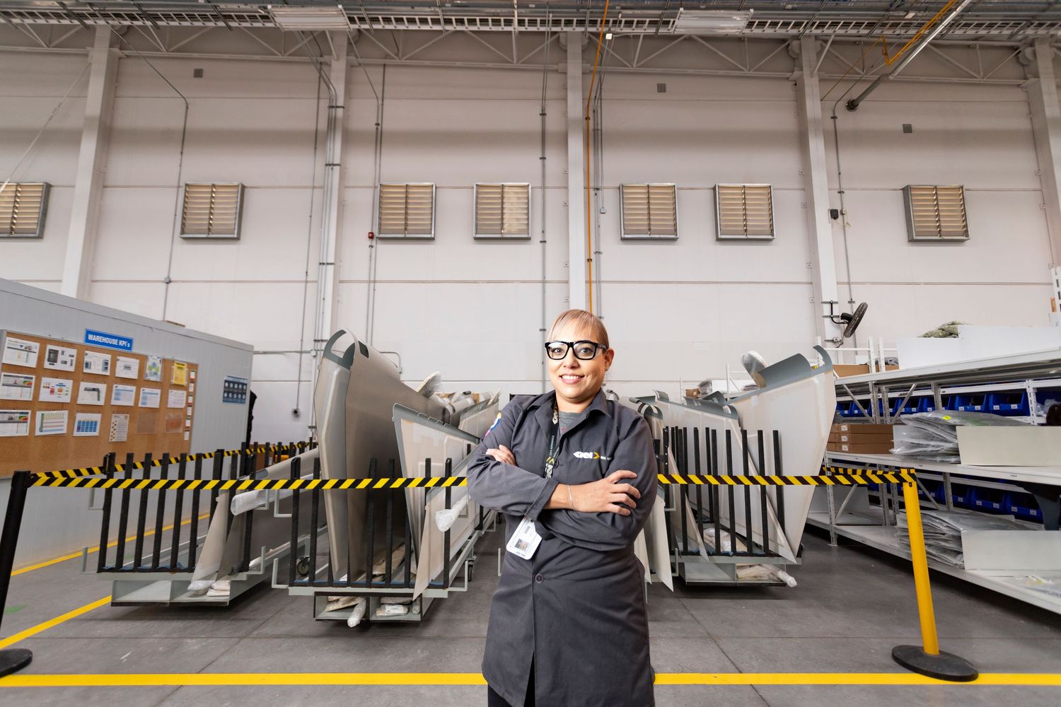 Loading dock workers operating machinery and equipment in a warehouse facility.