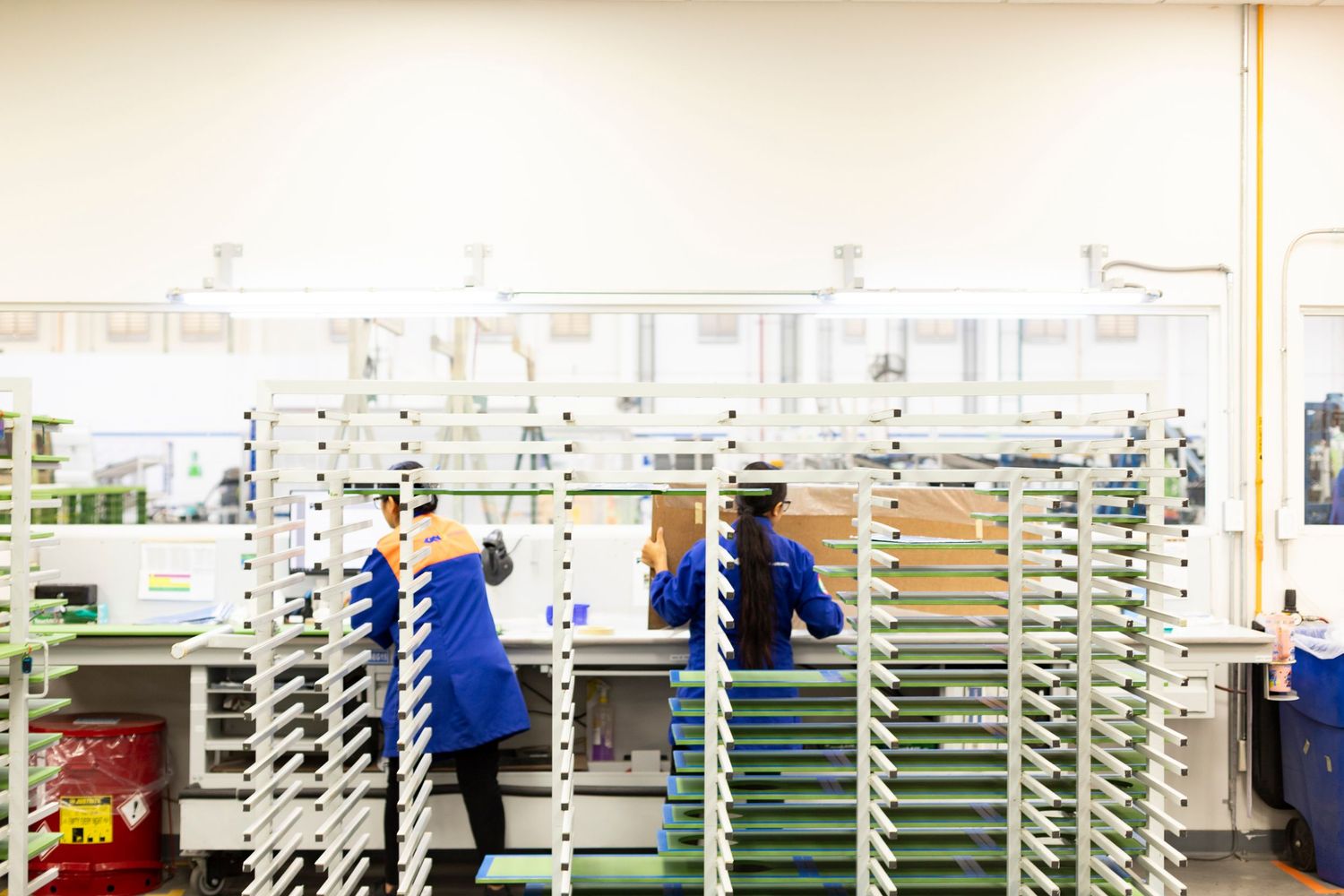 Pharmacy interior with rows of white shelving units and organized medication storage displays.