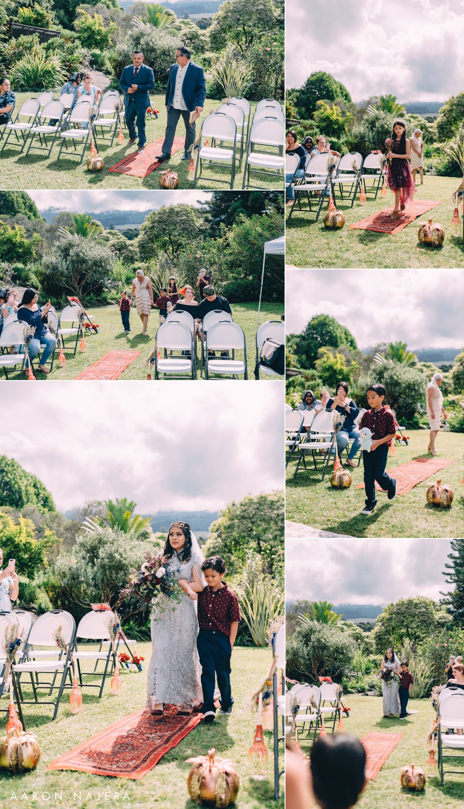 Outdoor garden wedding ceremony setup with white chairs and red carpet aisle runner in a lush tropical setting.