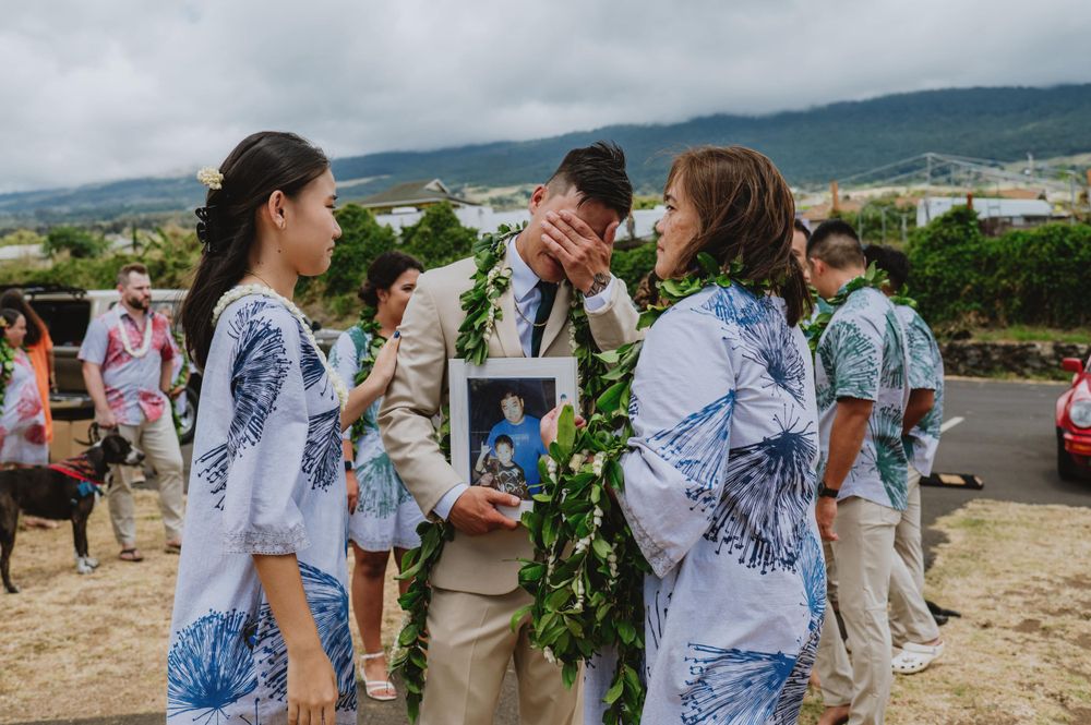 Outdoor gathering with guests wearing blue and white tropical print attire.