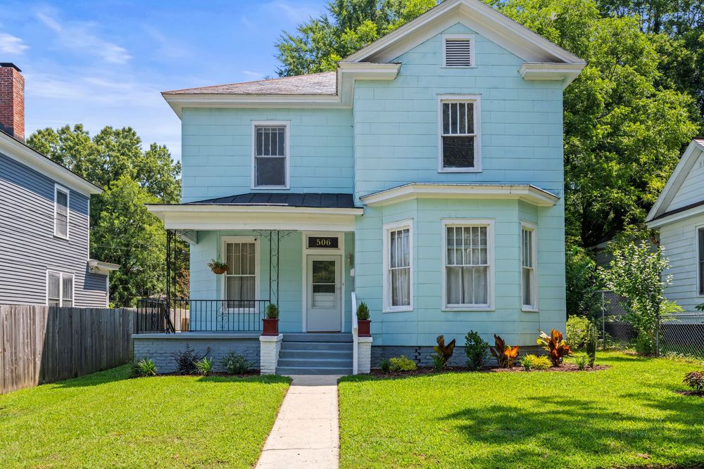 White colonial style house with green lawn and landscaping viewed from multiple angles in panoramic format.