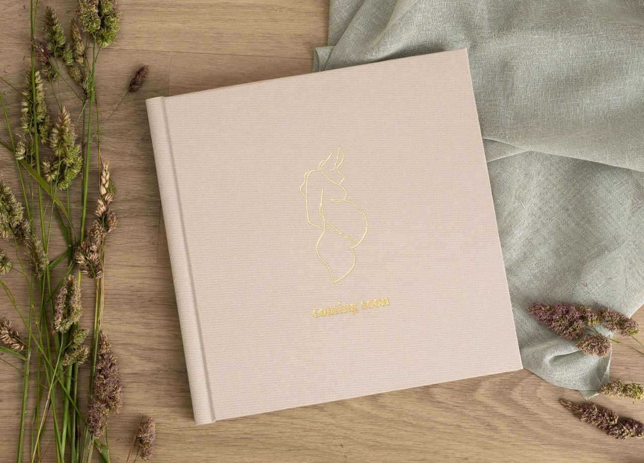 Hand-crafted luxury newborn album with linen cover and museum-grade printing.