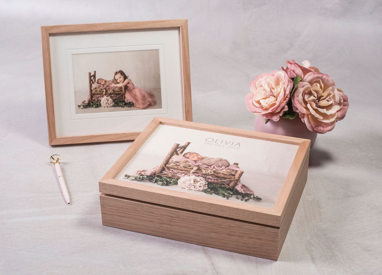 Custom designed heirloom baby album featuring professional newborn portraits