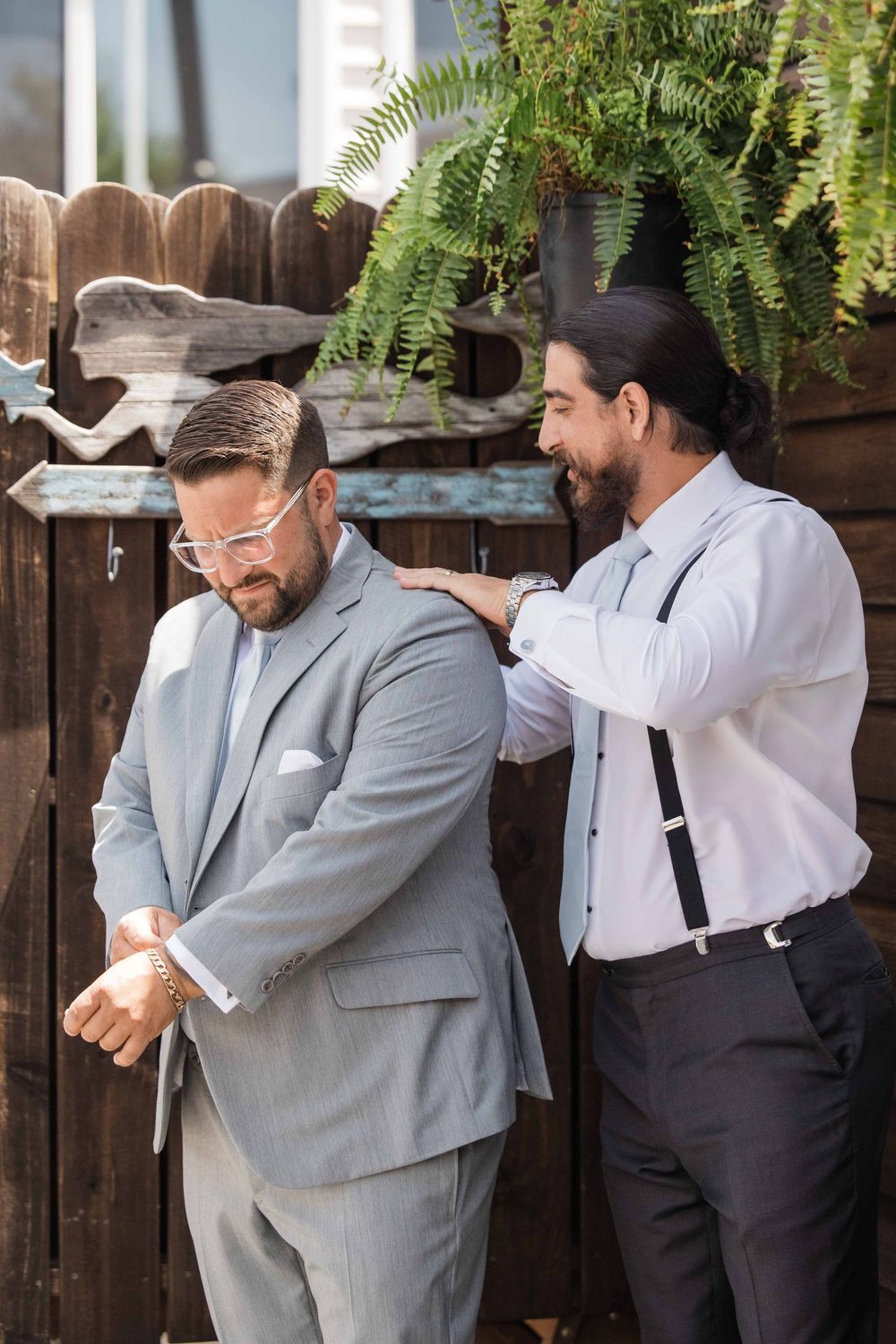 A playful sequence of photos showing two people in formal attire hugging and laughing together outdoors.