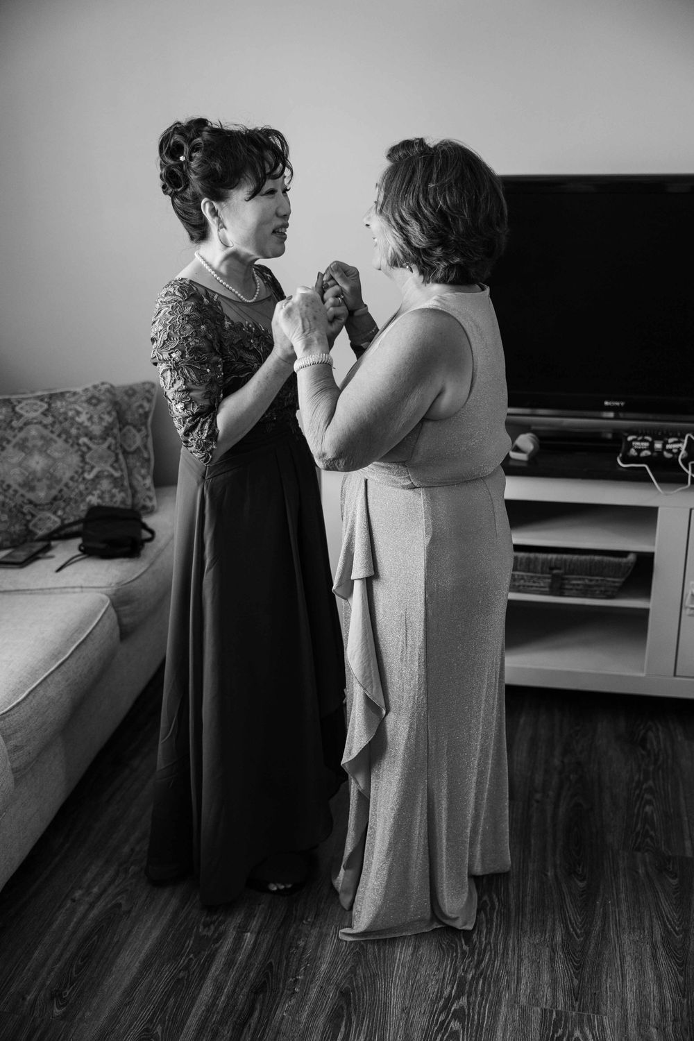 A series of black and white photographs showing two people dancing together in a living room with hardwood floors.