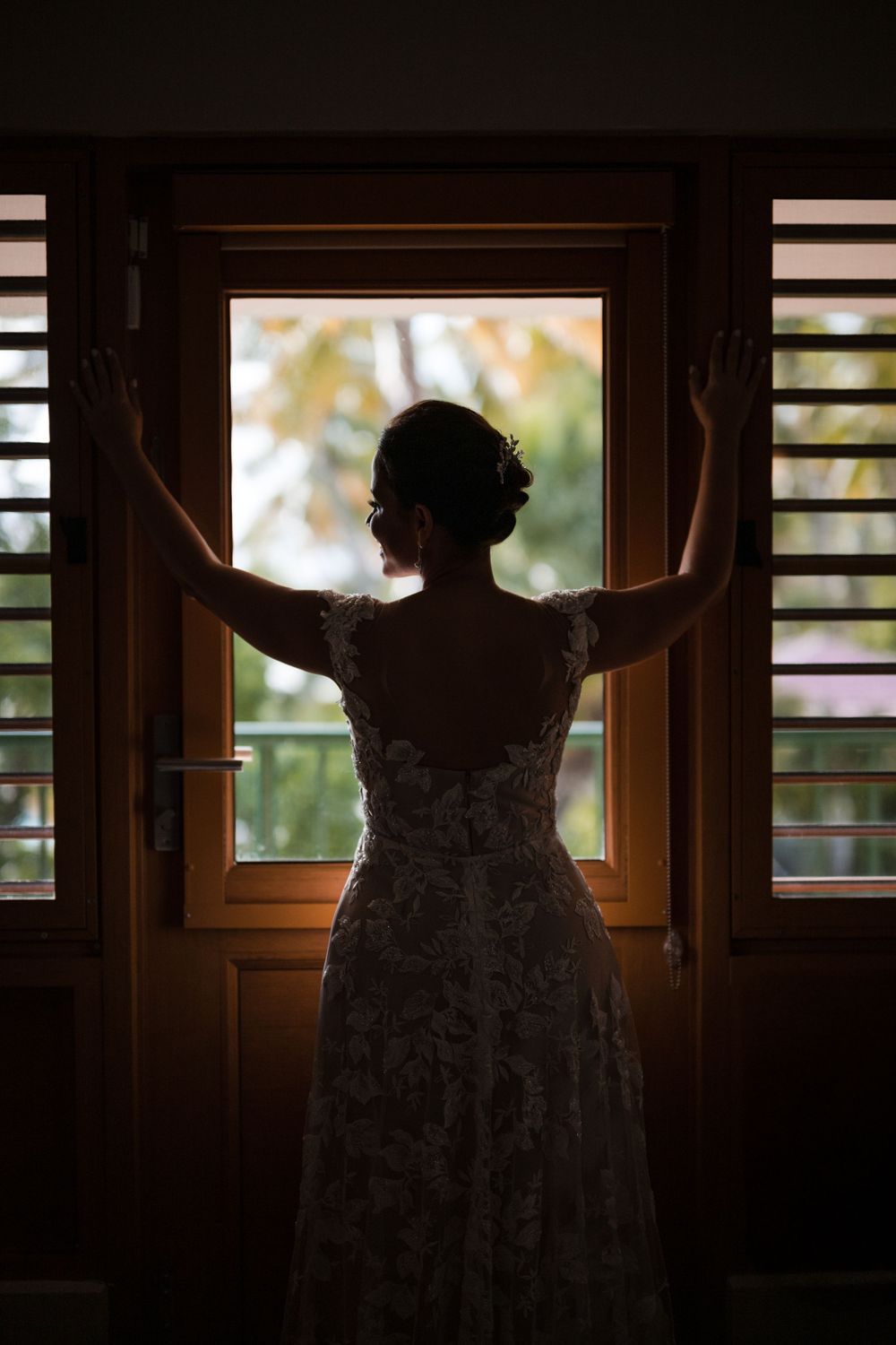 Bride silhouette near window during wedding preparation at Copamarina Puerto Rico