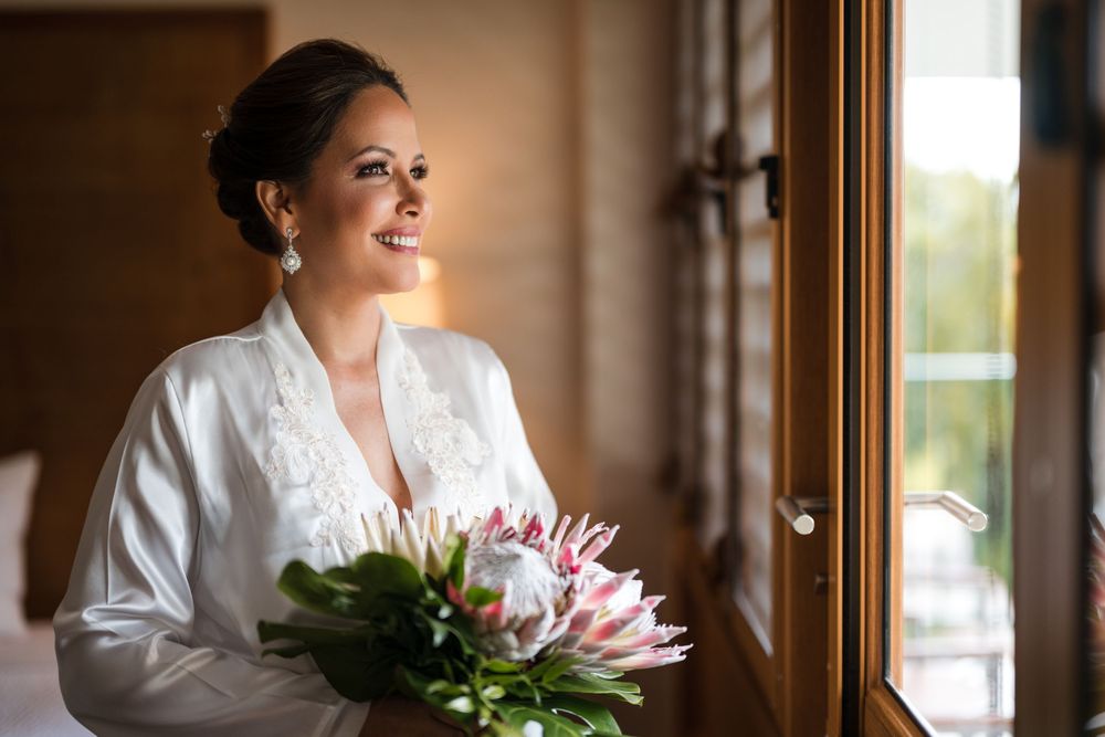 Bride holding bouquet during wedding preparation at Copamarina Beach Resort