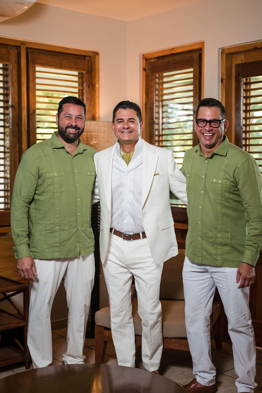 Groom smiling during preparation with friends at Copamarina Beach Resort