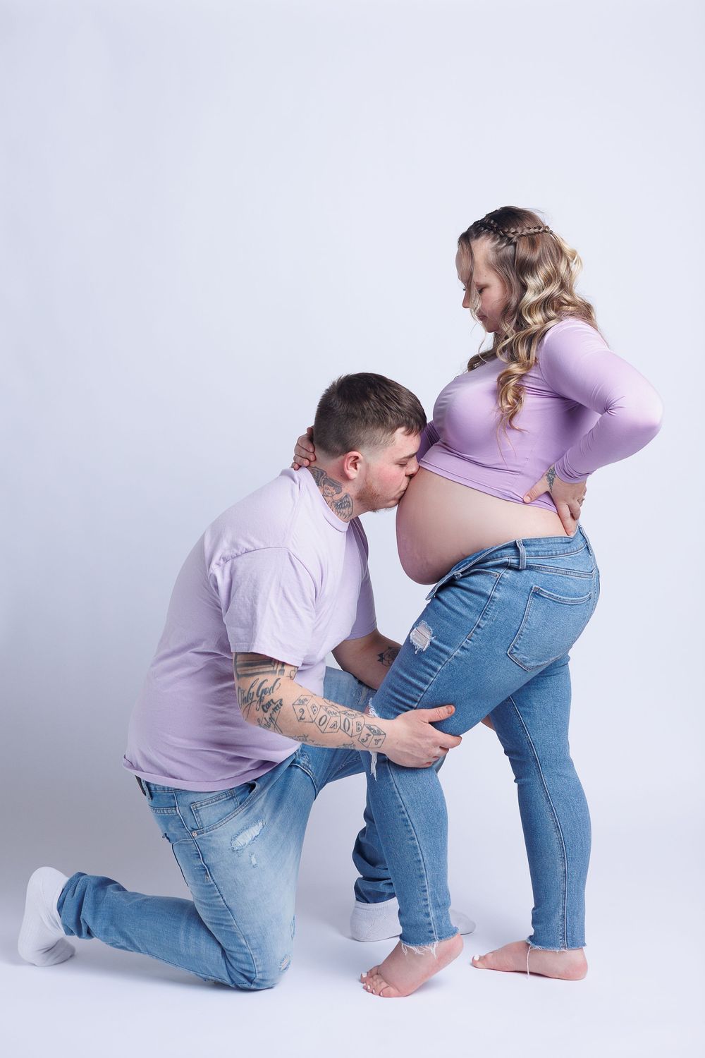 Maternity photo sequence showing a couple in matching lavender shirts posing together against white background.