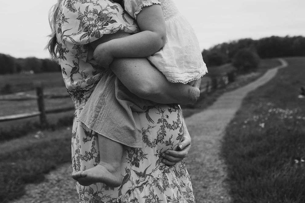 A tender black and white embrace captured on a countryside path.