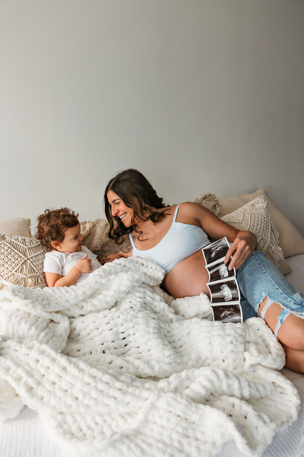 A cozy moment shared under a chunky knit blanket.