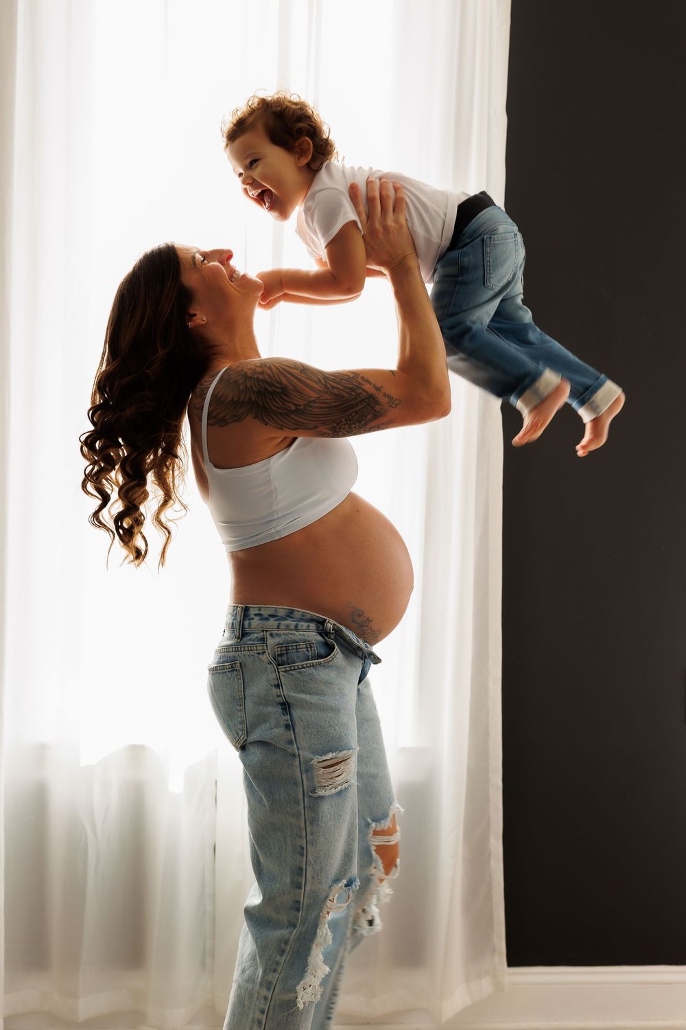 A joyful moment captured against a bright window.
