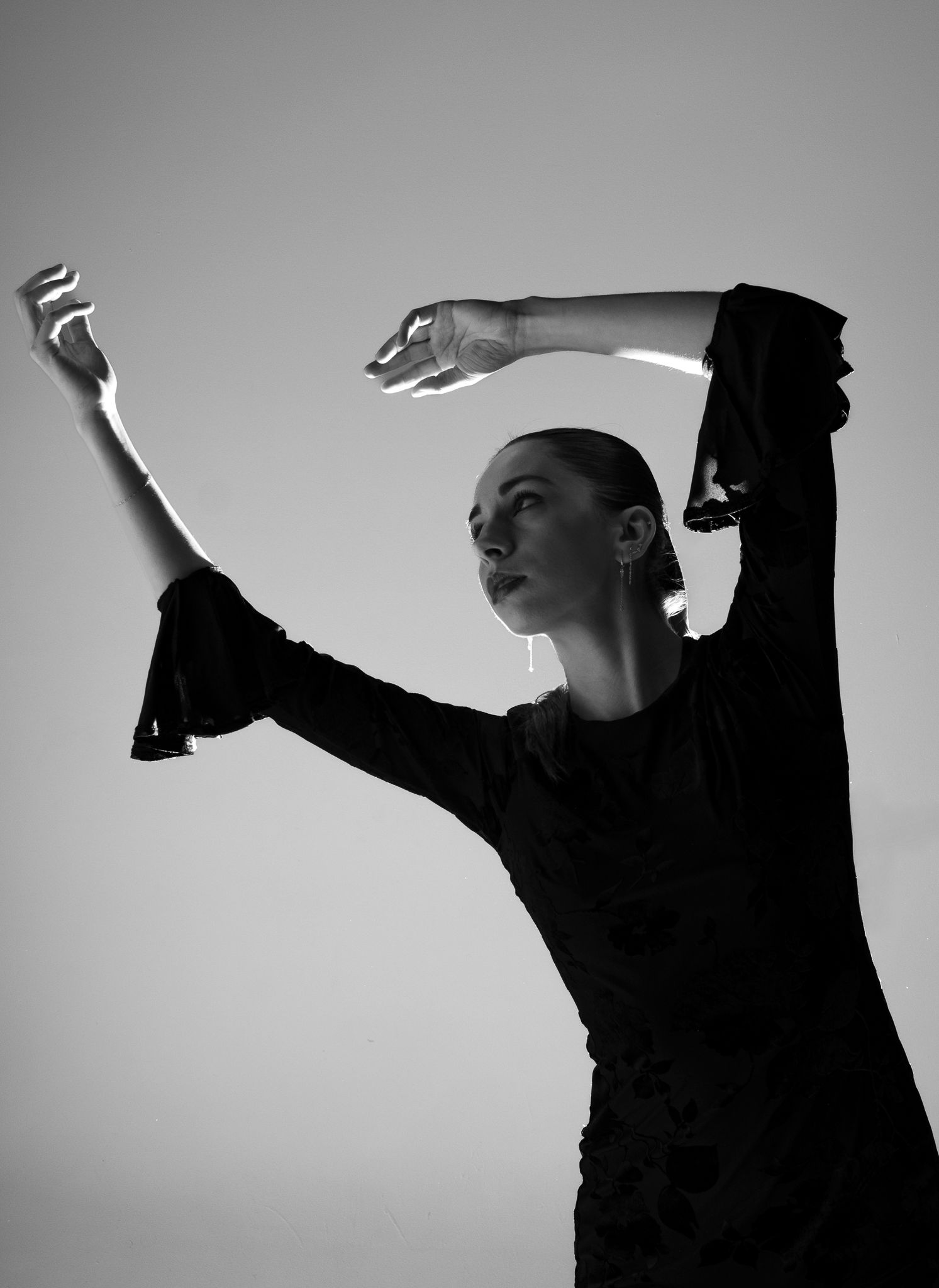 Artistic black and white silhouette series showing expressive dance movements.