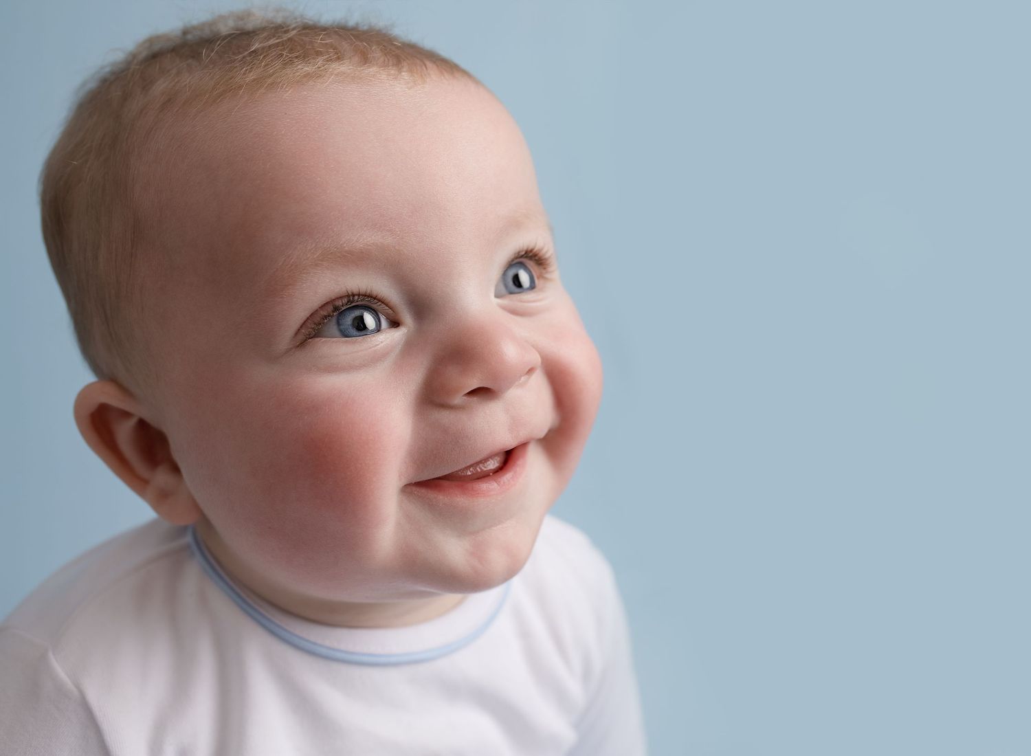 baby boy around six months old, side profile of a big smile and wide eyes during a fun milestone baby photoshoot near Glasgow