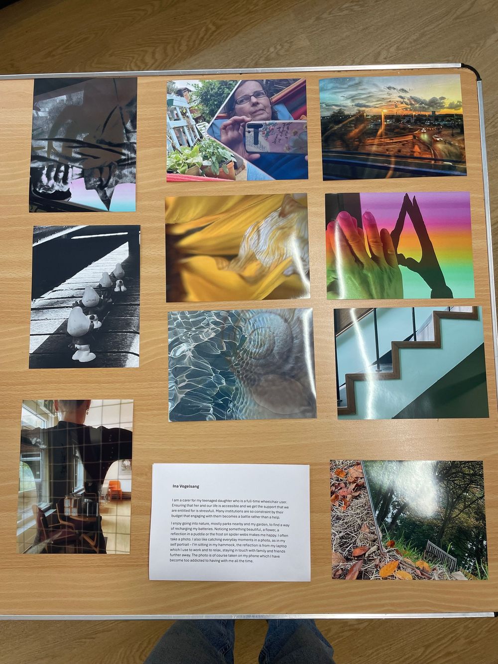 Collection of artistic photographs showing architectural details, staircases, and abstract patterns arranged on a wooden surface.