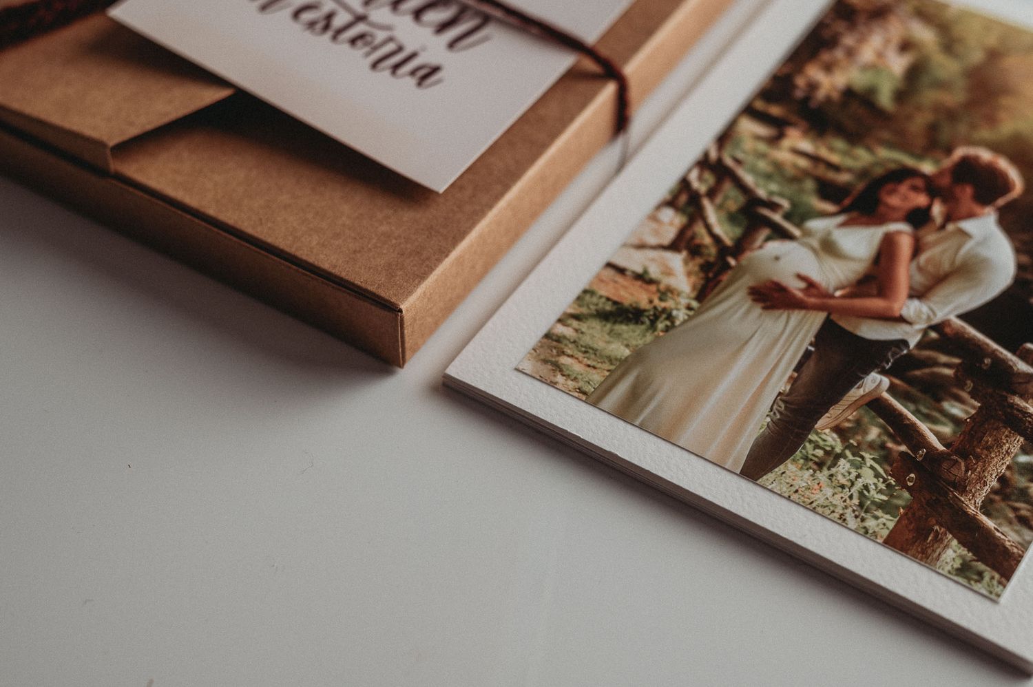 Close-up detail of a wrapped photo album with twine string and attached wedding photo.