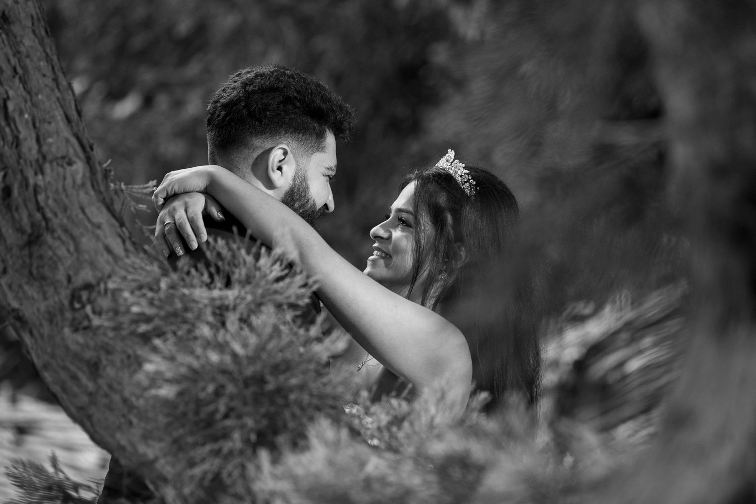 A black and white photo series of dancers performing expressive movements in a natural outdoor setting.