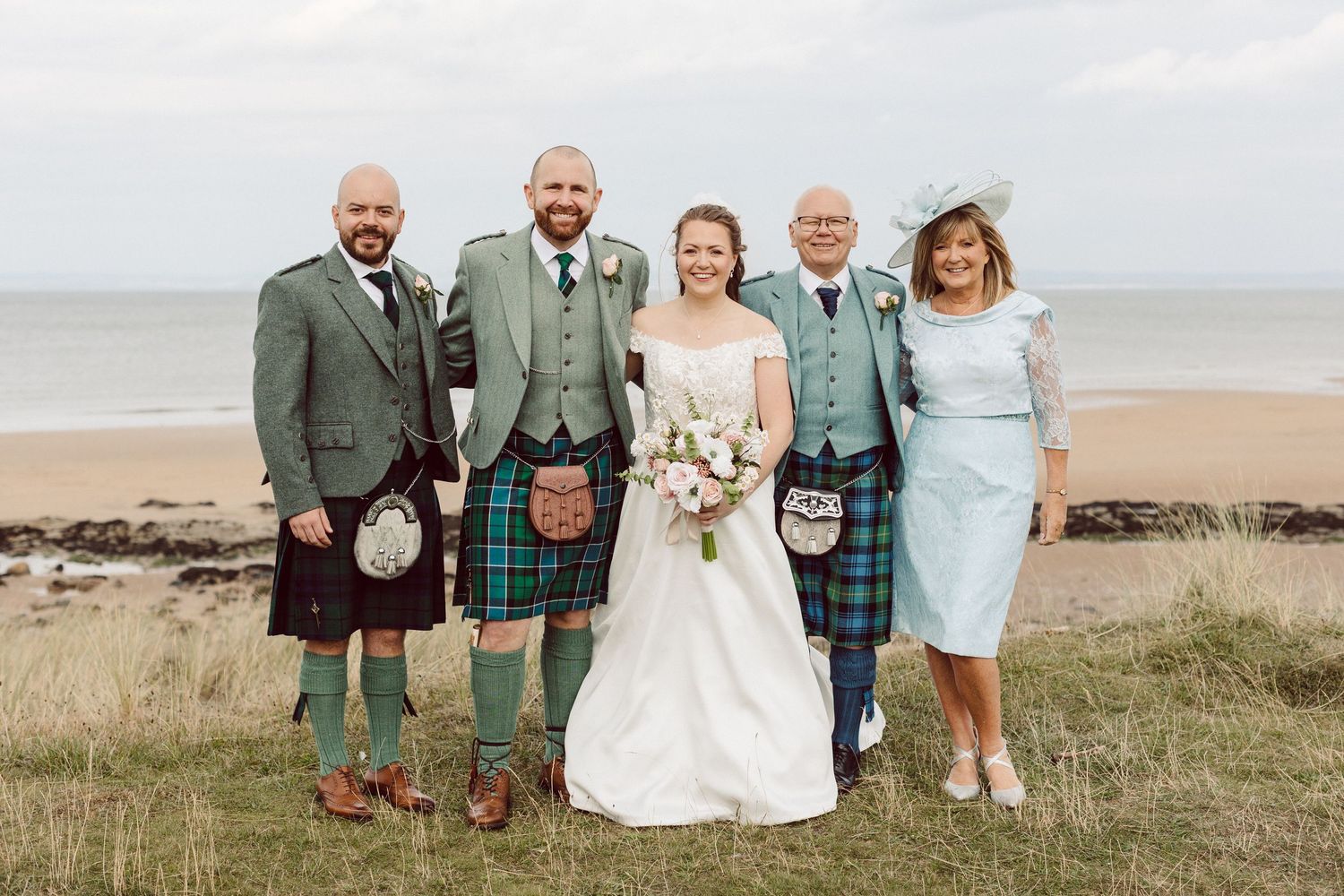 A series of wedding photos showing people in traditional Scottish kilts and formal attire posing on a scenic beach and grassy hillside.