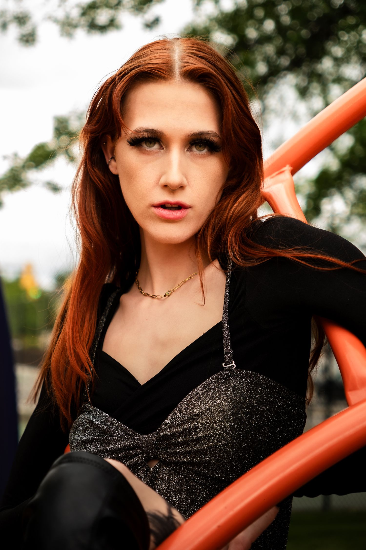 Glamorous self-portrait series taken in car featuring red lipstick and gold chain accessories.