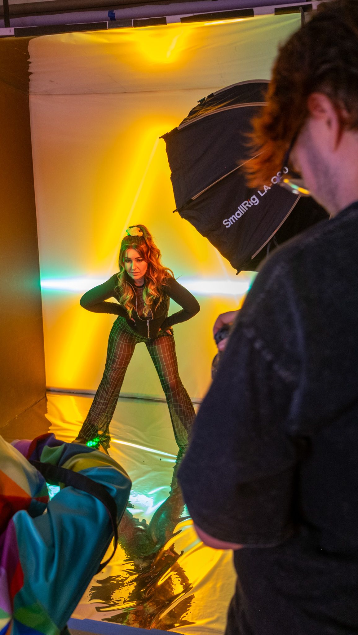 Sequence of photos showing a person in black clothing posing dramatically with an umbrella against yellow lighting.