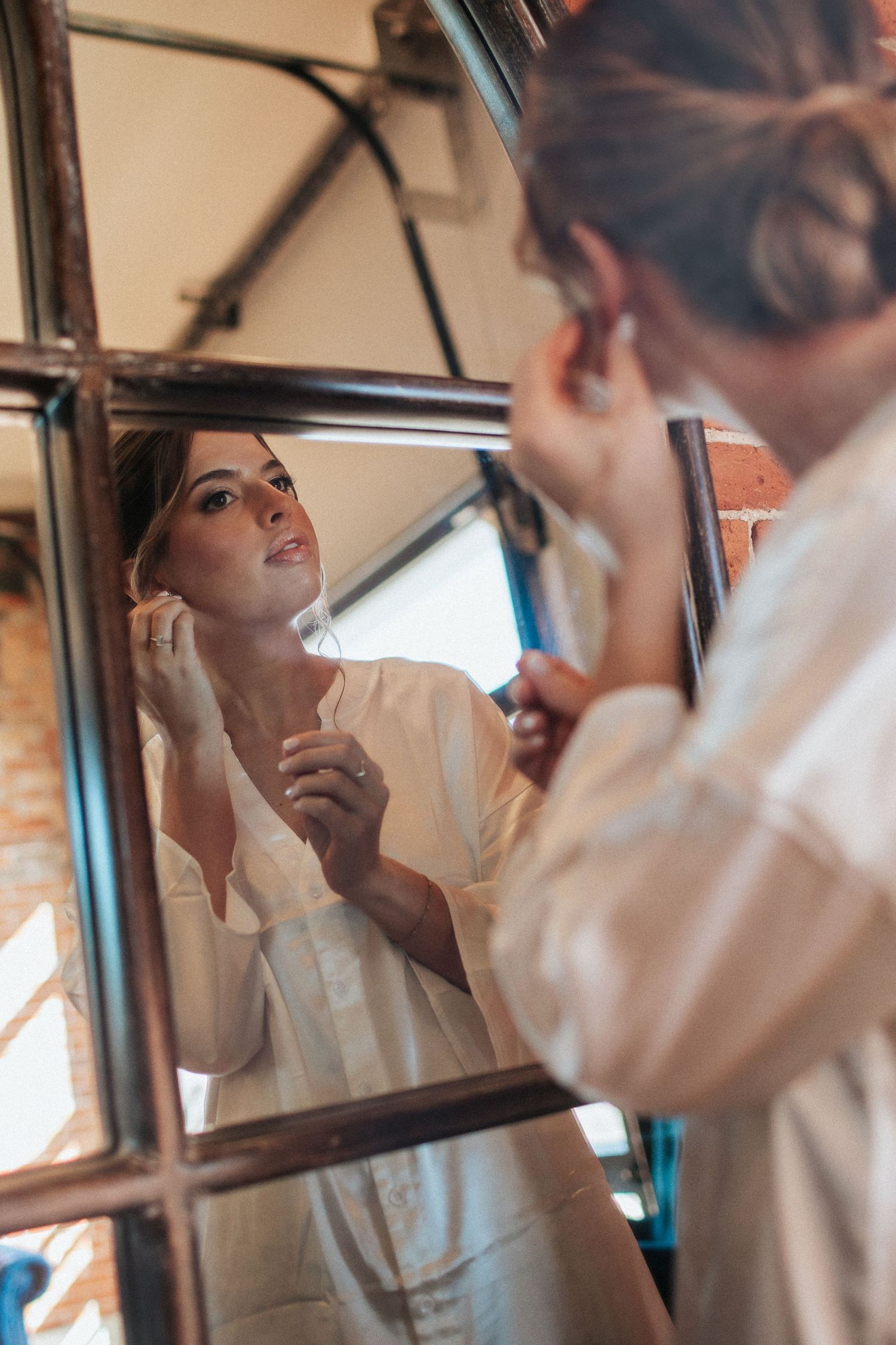 Mirror reflections in vintage-style frames during wedding preparation.