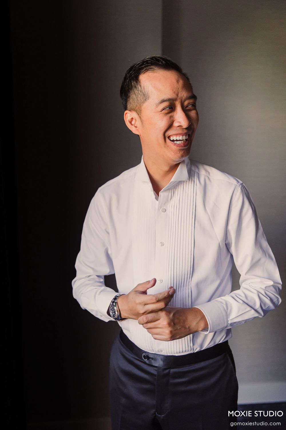 Candid sequence of someone in formal attire expressing joy while adjusting their collar.