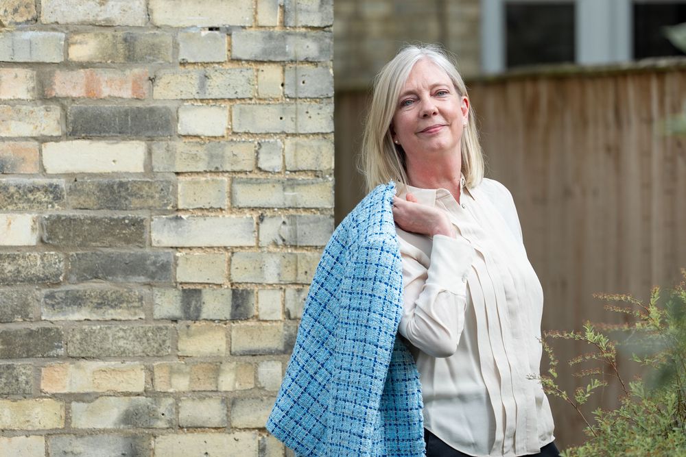 A sequence of playful expressions and poses against a brick wall while wearing a white top and blue plaid shirt.