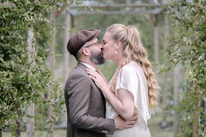 Intimate wedding couple portraits captured among green foliage and natural surroundings.