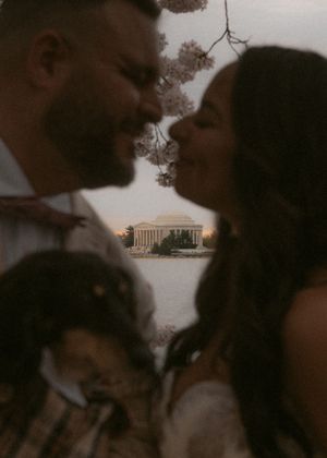 Wedding couple shares intimate moments near the Jefferson Memorial during sunset.