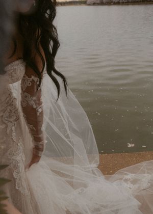 Wedding dress details with delicate lace and flowing tulle veil near the Tidal Basin.