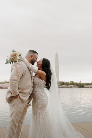 Romantic wedding portraits by the water with Washington Monument in background.