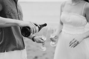 champagne toast engagement photos Moncton New Brunswick photographer sessions couple celebrating newly engaged beach photography candid