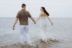 Couple running in the water romantic date night picnic Parlee Beach photographer Shediac proposal photographer New Brunswick best photo