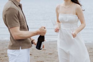 couple toasting to engagement beach photography session romantic couples portraits Shediac photographer Parlee beach photography freelance