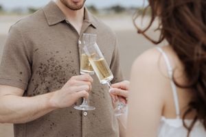 cheers toast champagne engagement celebrations Shediac photographer engagement session beach engagement portrait session beach proposal