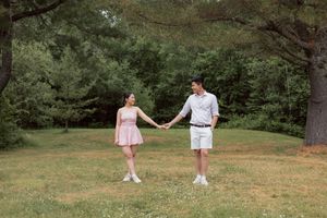 Couple hold hands under tree arch in Irishtown Nature Park in Moncton New Brunswick couples photographer, romantic engagement photos Canada