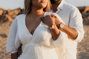 couple embracing at sunset at Parlee beach in Cap Pele New Brunswick engagement photography vacation photos golden hour