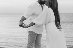 couple dancing in the ocean at sunset at Parlee beach in Cap Pele New Brunswick engagement photography vacation photos golden hour
