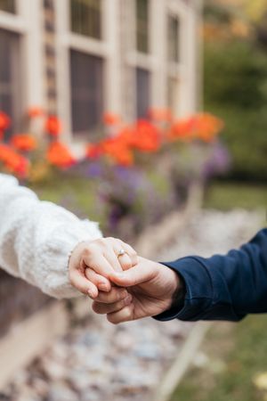 Couple hold hands during romantic fall engagement session, engagement photography Bouctouche New Brunswick, Moncton couples photographer