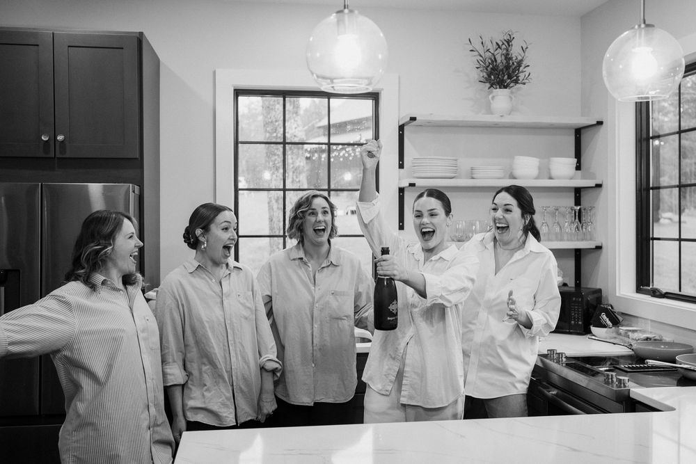 A sequence of black and white photos showing people dancing and laughing together in an office setting.