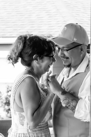 Sequence of black and white photos showing tender romantic moments between a couple in wedding attire.