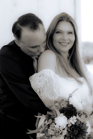 A romantic wedding photo series showing tender moments between a couple with a black and white bouquet.