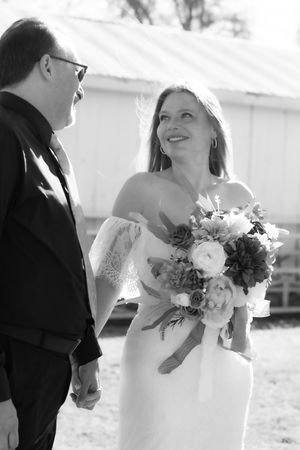 Black and white wedding photo series showing intimate moments between a couple with bridal bouquet of mixed flowers.