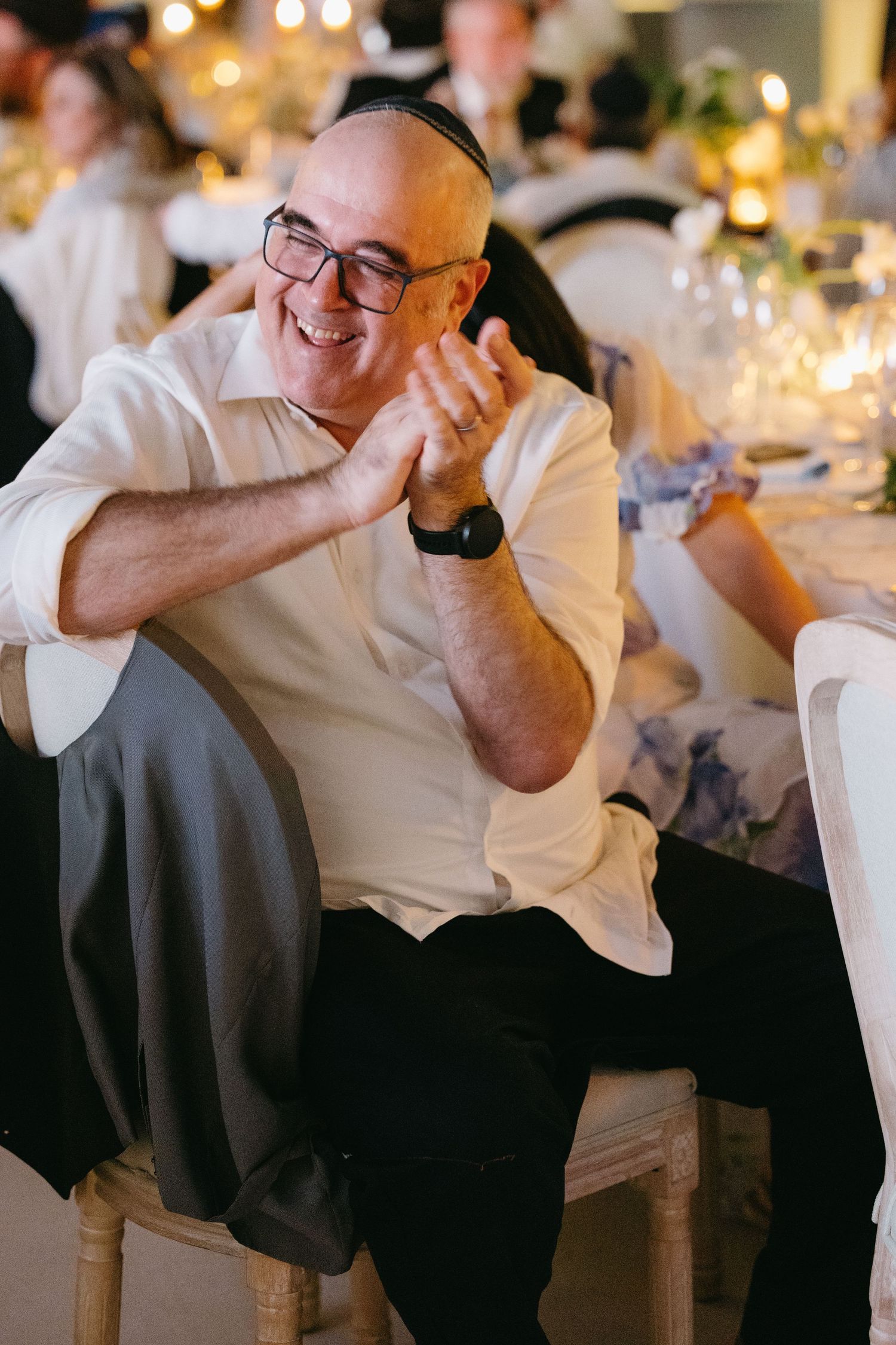 Wedding guest laughing and enjoying emotional moments during the reception celebrations.