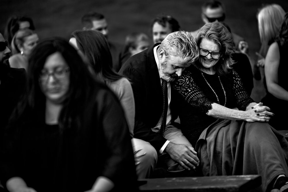 Black and white candid photographs show intimate moments at a wedding celebration.